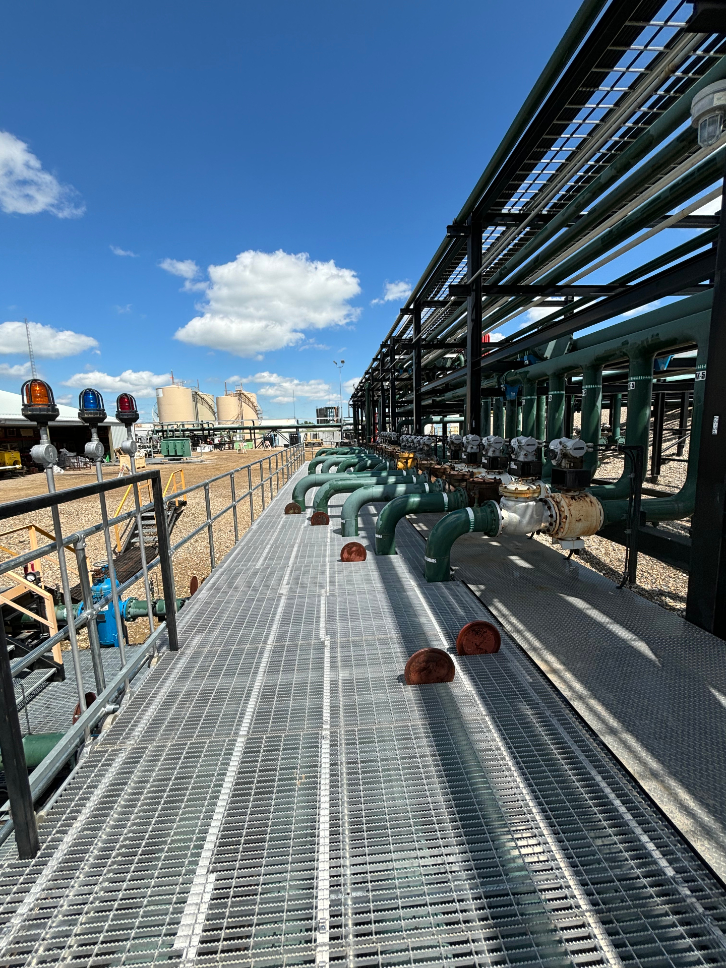 Industrial process rack with tanks and piping at height